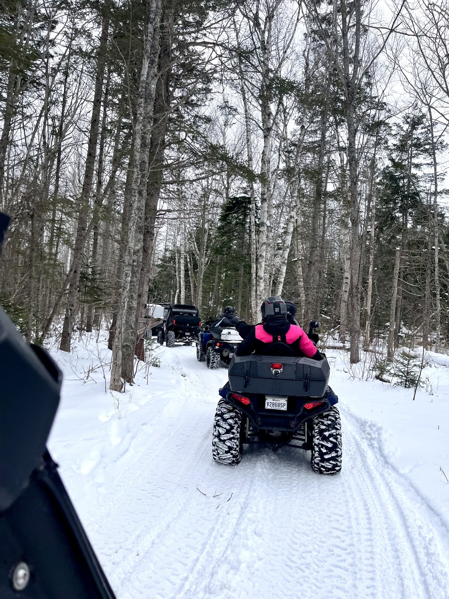 ATV riders travelling through snowy PEI trails
