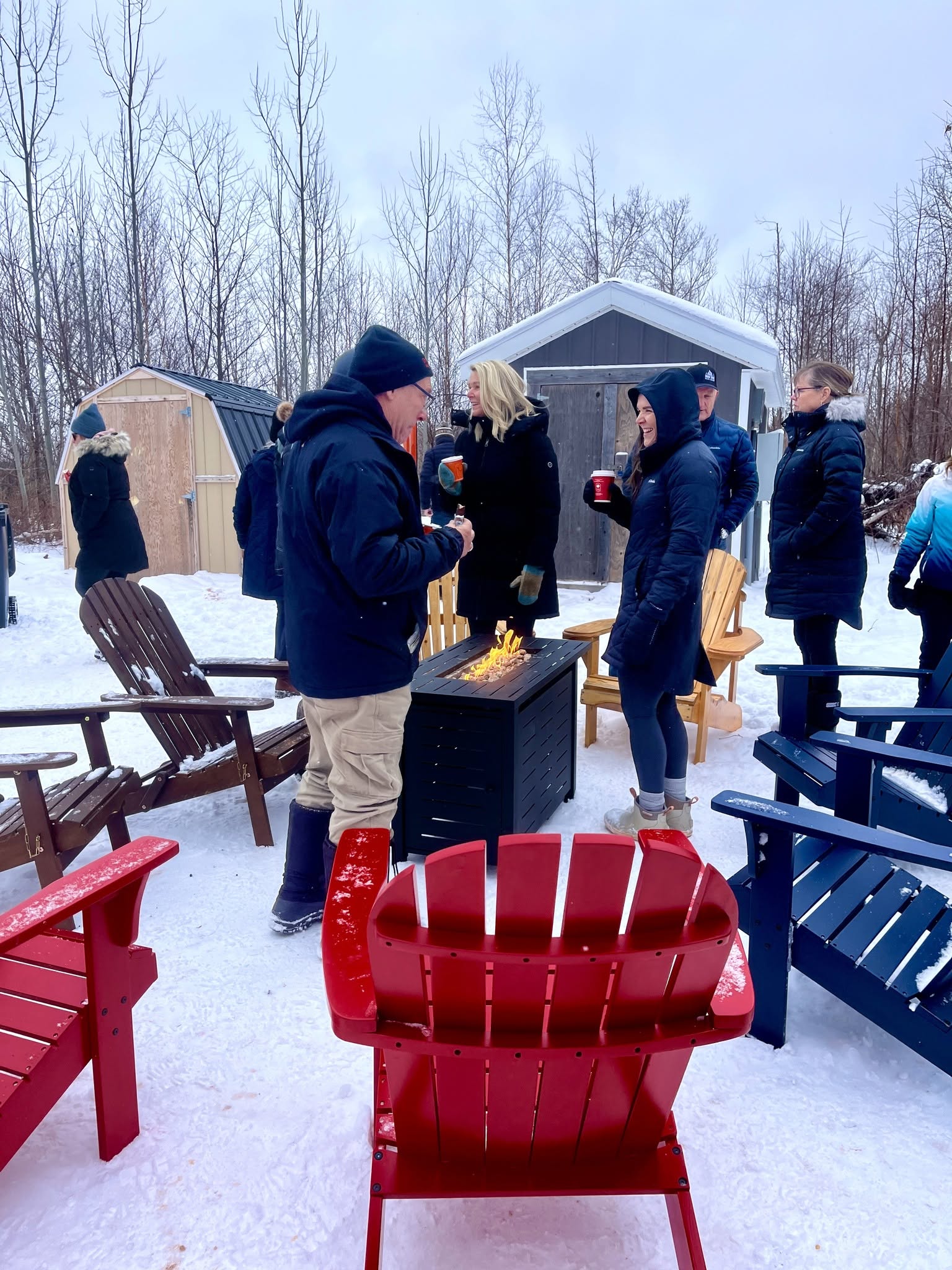 Friends gathering around a fire during a Red Dirt Ride trail stop