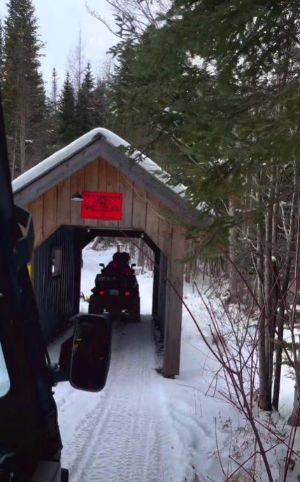 Red Dirt Ride participants travelling through a covered bridge
